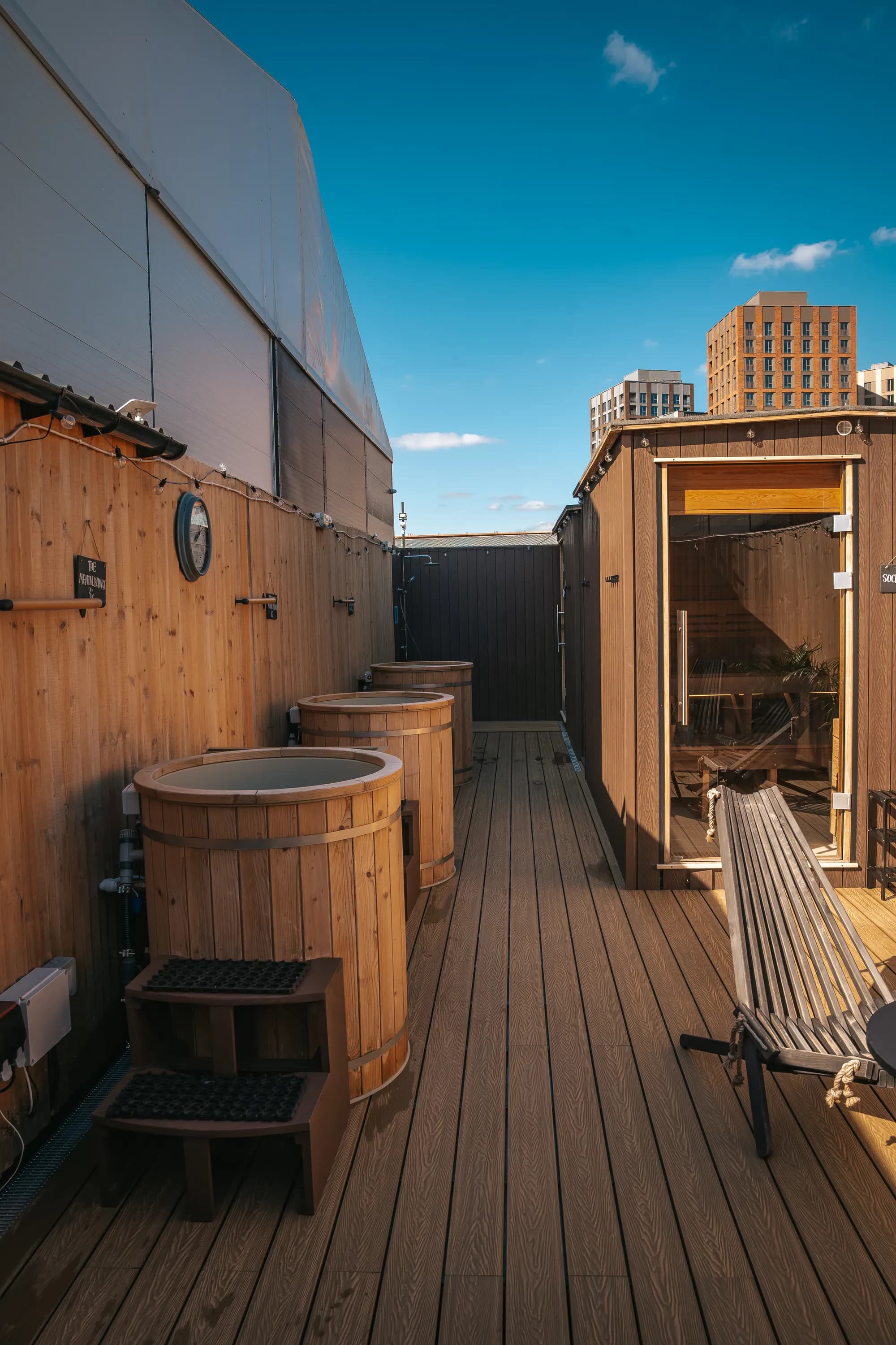 Timber deck with plunge tubs under blue sky